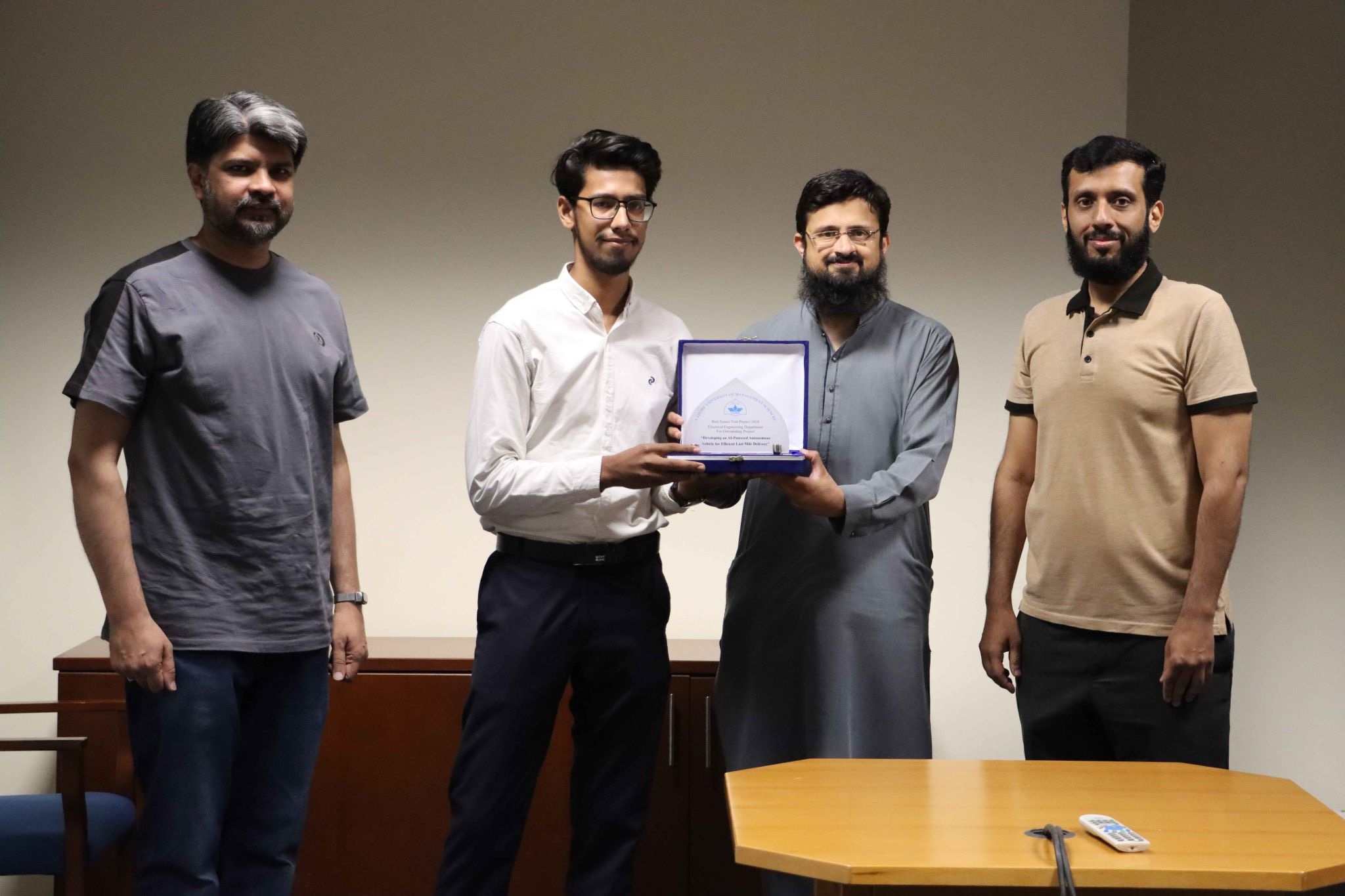 Ali Rehman receiving the Best Final Year Project 2024 award alongside LUMS faculty members